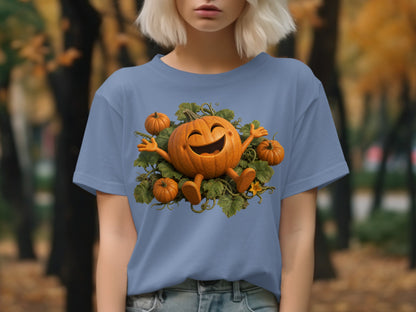 Blue t-shirt with smiling pumpkin and small pumpkins surrounded by green leaves.