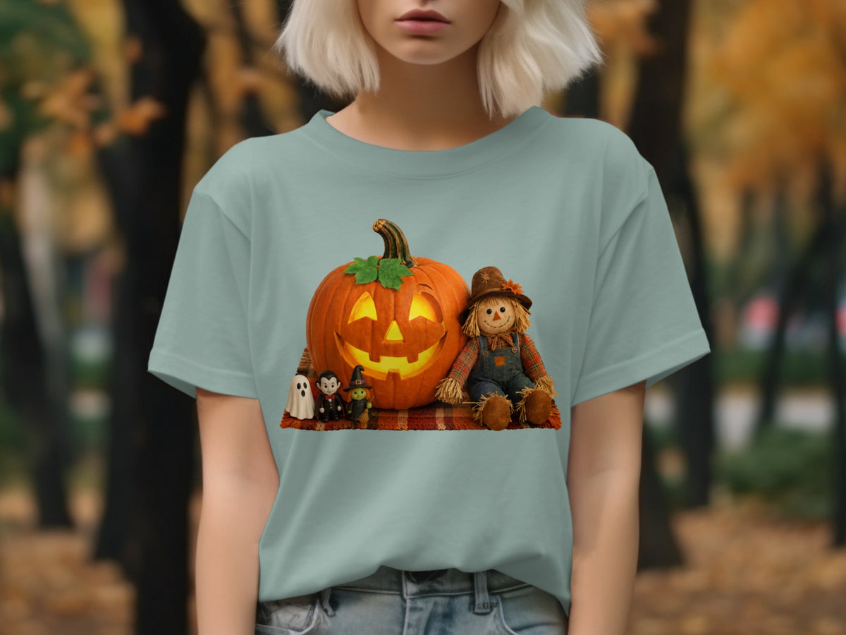 Jack-o-lantern with scarecrow, witch, and ghost figures on plaid blanket.