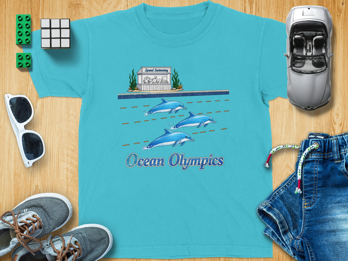 Teal t-shirt with dolphins swimming and "Ocean Olympics" text.