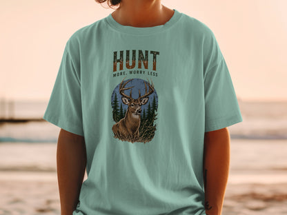 T-shirt graphic with text "HUNT MORE, WORRY LESS" and a deer in a forest scene.