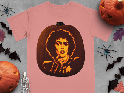 A pink t-shirt featuring a lit pumpkin carved with Dr. Frank-N-Furter from The Rocky Horror Picture Show.