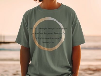 Green t-shirt with scripture and a circular design.