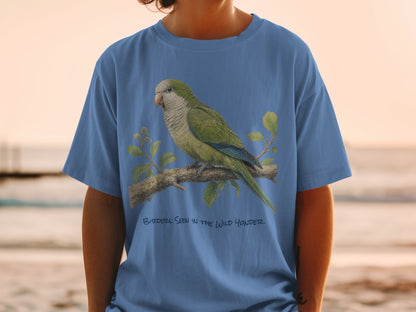 Blue t-shirt with illustration of a green parrot on a branch and text.