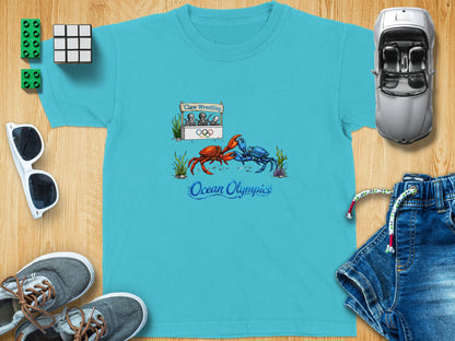 T-shirt with illustration of crabs wrestling under "Claw Wrestling" sign and "Ocean Olympics" text.
