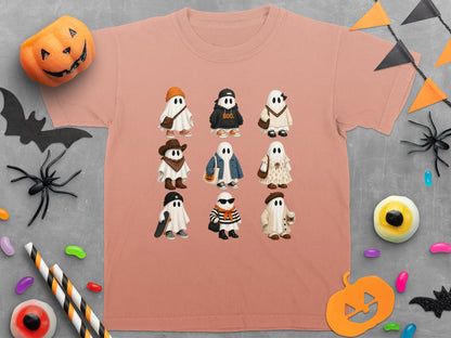 Peach t-shirt with nine ghosts in Halloween costumes and text "BOO.".