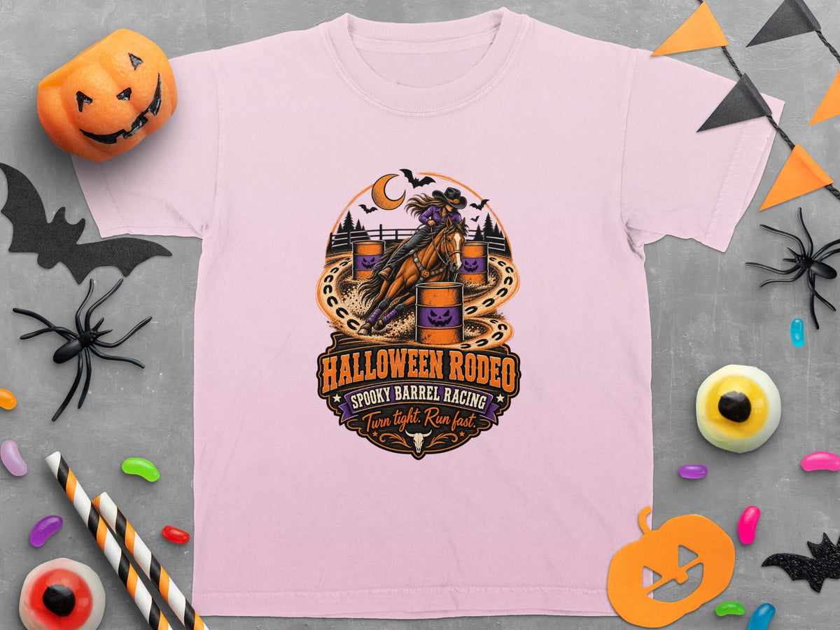 Pink t-shirt graphic of a cowgirl barrel racing, with "Halloween Rodeo Spooky Barrel Racing Turn tight. Run fast." text.