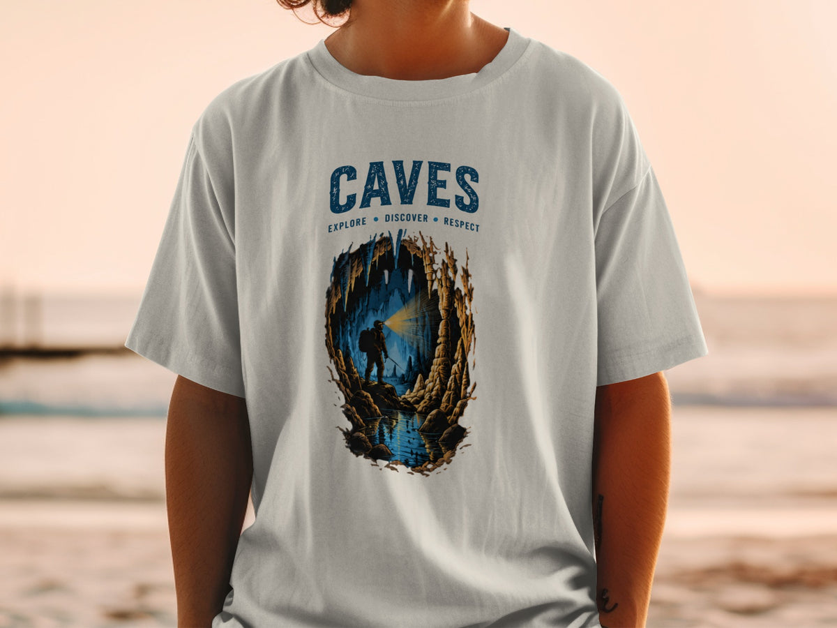 T-shirt graphic featuring "CAVES" and a caver exploring a cave with a flashlight.