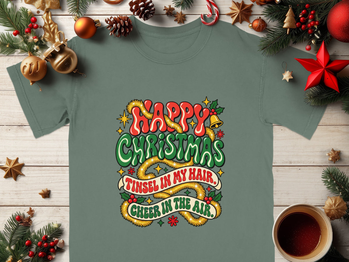 Green t-shirt with "Happy Christmas Tinsel in My Hair Cheer in the Air" text.