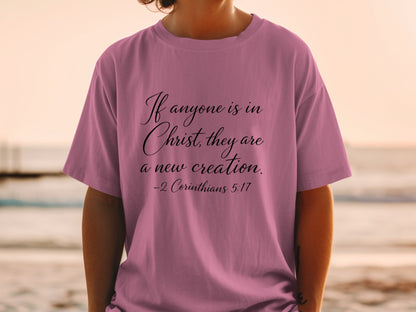 Mauve t-shirt with black text: "If anyone is in Christ, they are a new creation. -2 Corinthians 5:17"