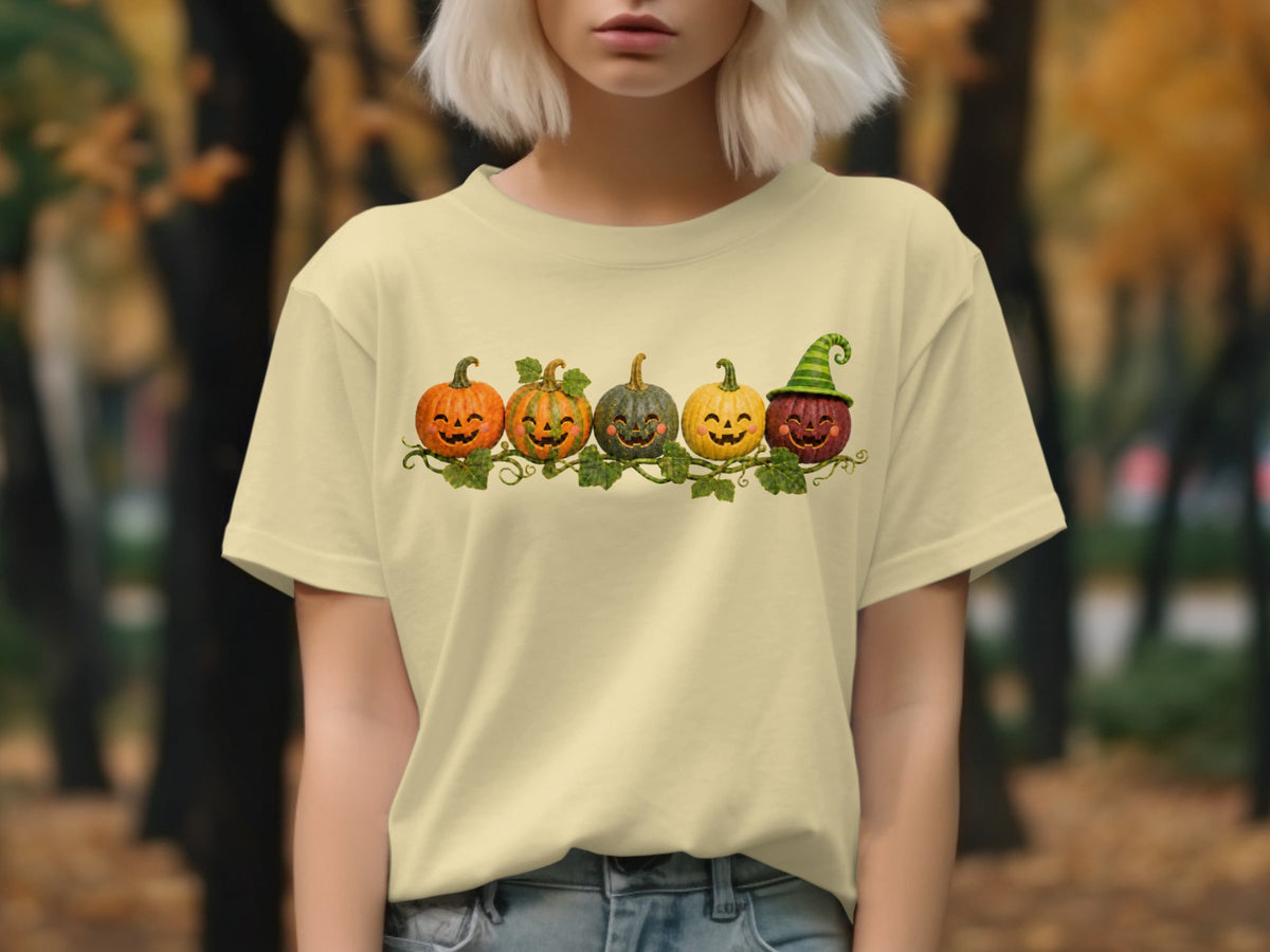 Cream t-shirt with five smiling Jack-o'-lanterns on a vine.