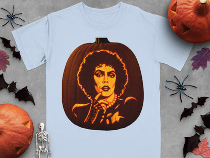 Light blue t-shirt featuring a lit jack-o'-lantern carved with the face of Dr. Frank-N-Furter, surrounded by Halloween decorations.
