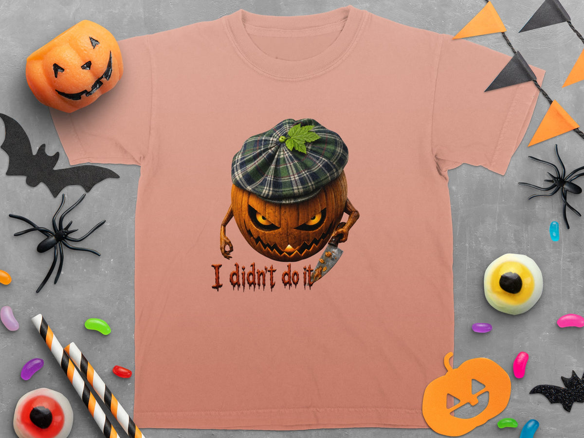 Peach t-shirt with grinning pumpkin wearing plaid hat and holding knife, text "I didn't do it".