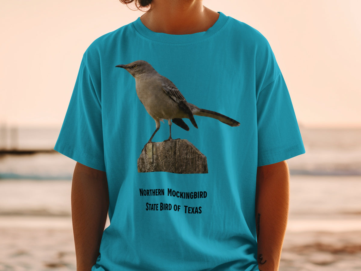 Northern Mockingbird, State Bird of Texas, printed on a teal t-shirt.