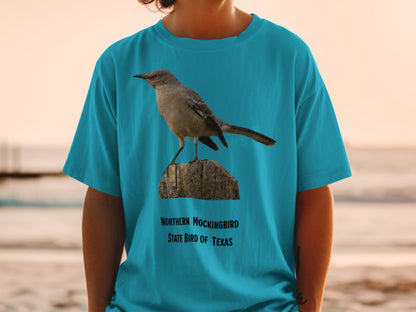 Northern Mockingbird, State Bird of Texas, printed on a teal t-shirt.