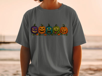 T-shirt with a row of five cartoon Halloween pumpkins with different funny faces.