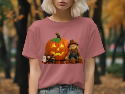 Pink t-shirt with Halloween graphics of a pumpkin, scarecrow, witch, vampire, and ghosts.