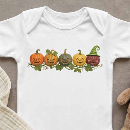 White baby bodysuit with a row of smiling jack-o'-lanterns and a witch hat.