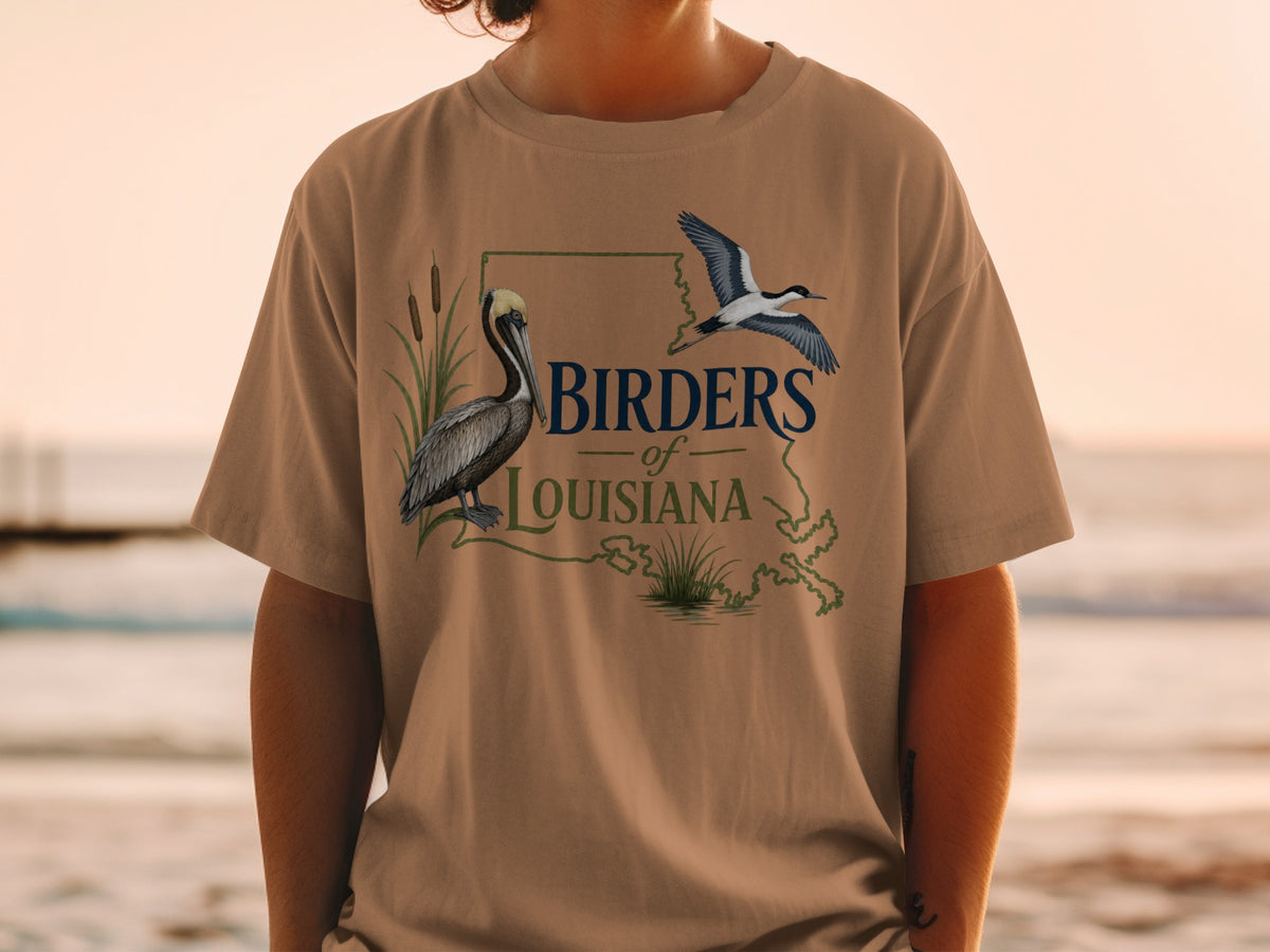 Brown t-shirt with "Birders of Louisiana" text and graphics of pelican and flying bird.