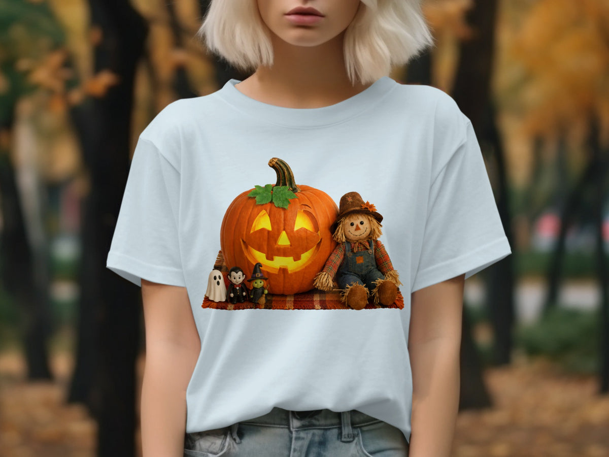 White t-shirt with a Halloween graphic featuring a jack-o'-lantern, scarecrow, and small figures.