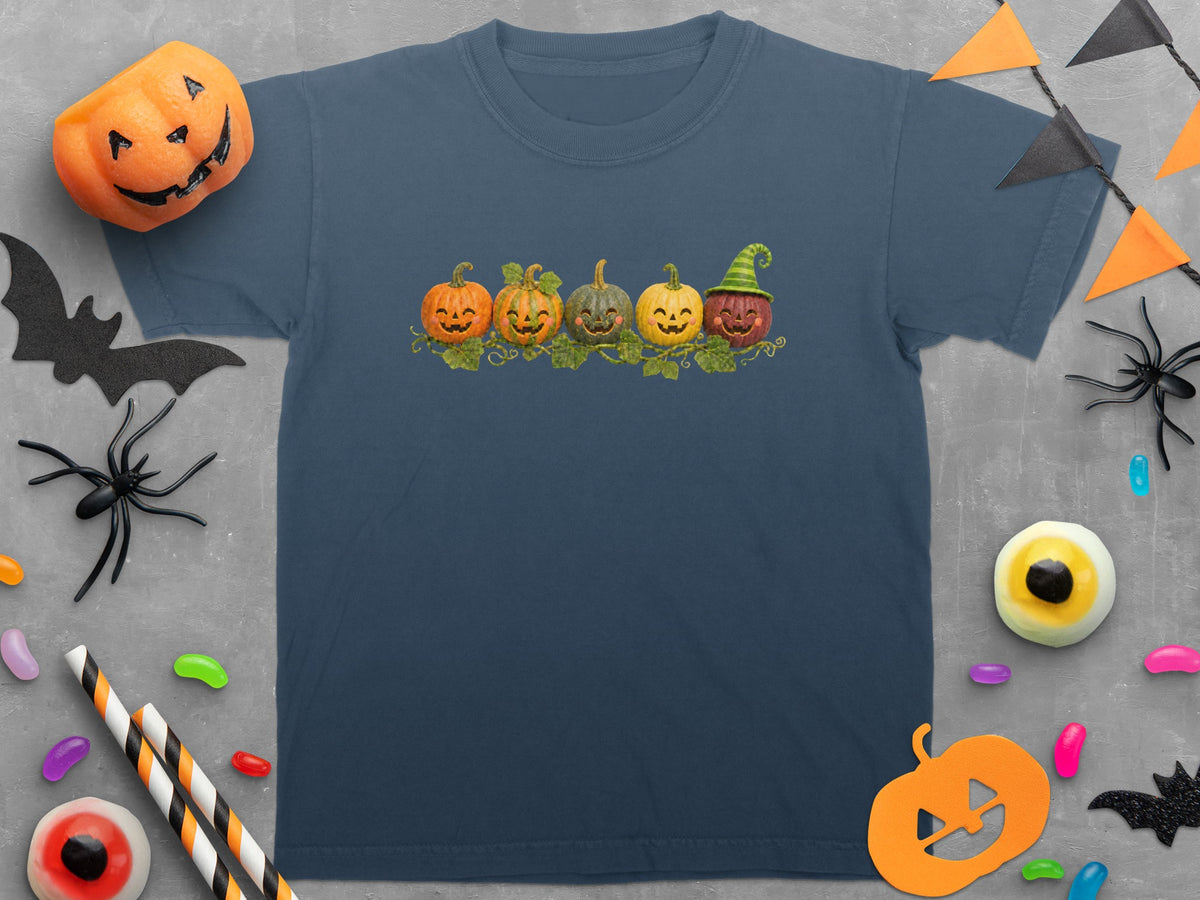 T-shirt with five smiling pumpkins in a row, one wearing a witch hat.
