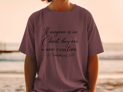 T-shirt with black text: "If anyone is in Christ, they are a new creation. -2 Corinthians 5:17"