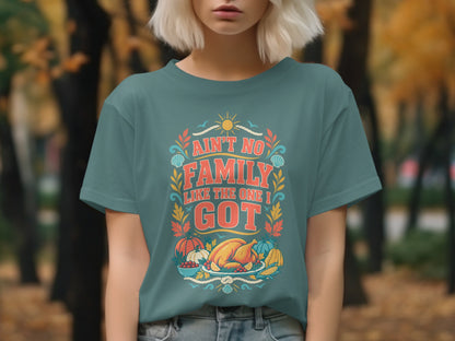Teal t-shirt with "Ain't No Family Like the One I Got" text and Thanksgiving imagery.