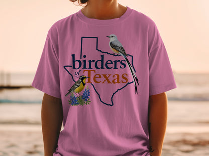 Pink t-shirt with "birders of Texas" text and two birds within the Texas outline.