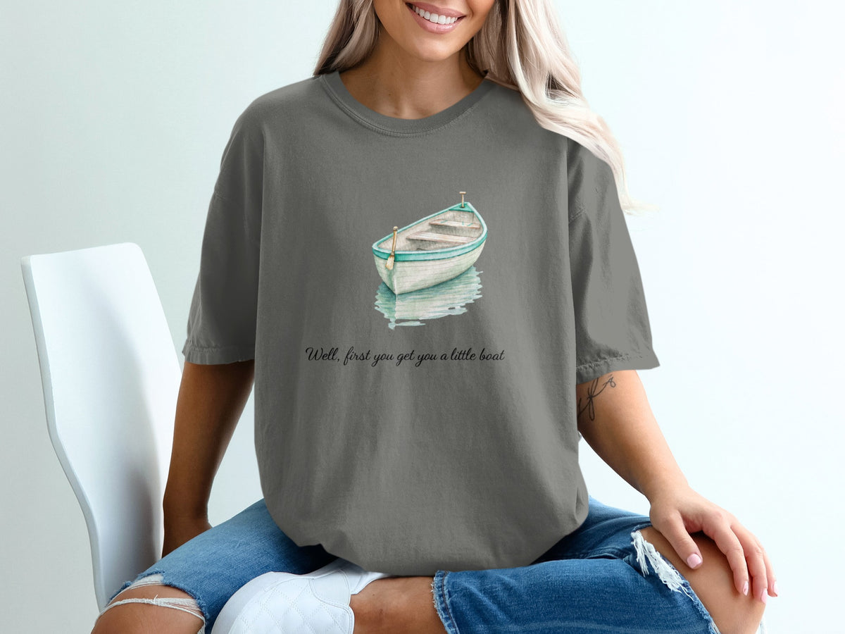Gray t-shirt with watercolor rowboat graphic and text "Well, first you get you a little boat".