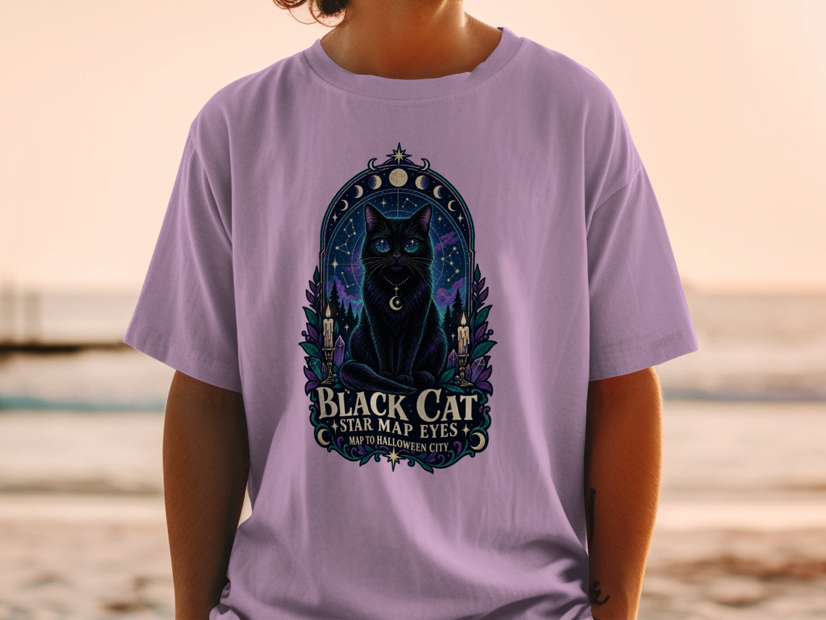 Black cat with star map eyes on a purple t-shirt, text reads "Black Cat Star Map Eyes Map to Halloween City".