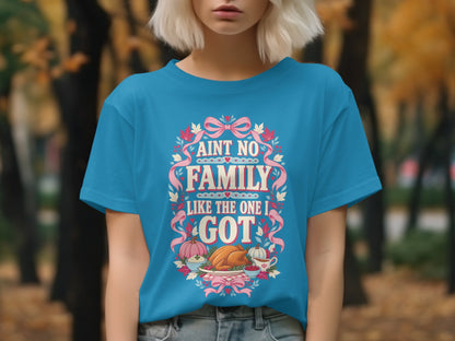 Turquoise t-shirt with "Ain't No Family Like the One I Got" Thanksgiving graphic.