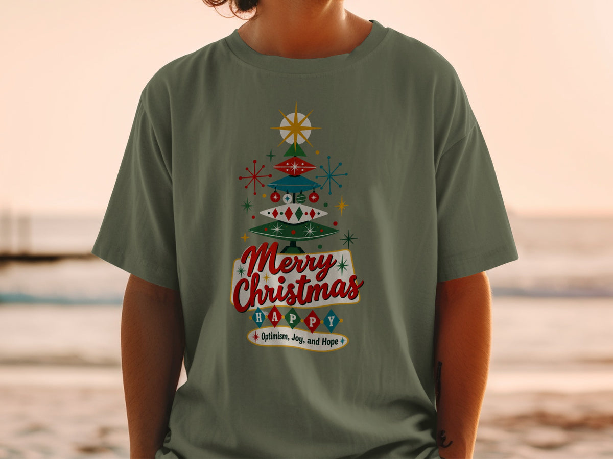 Green t-shirt with a retro Christmas tree graphic and text: Merry Christmas HAPPY Optimism, Joy, and Hope.