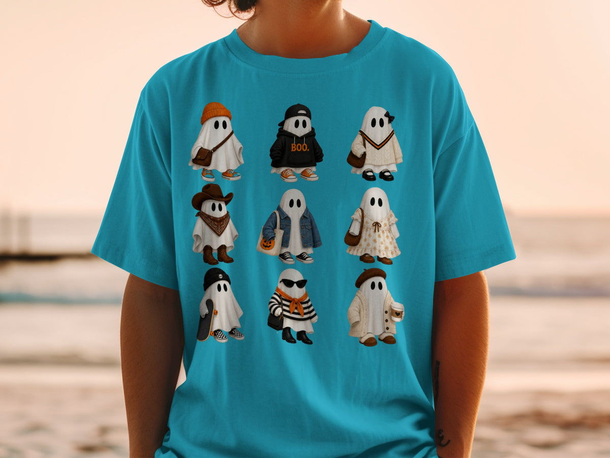 A graphic of nine cute ghosts in different outfits on a teal t-shirt.