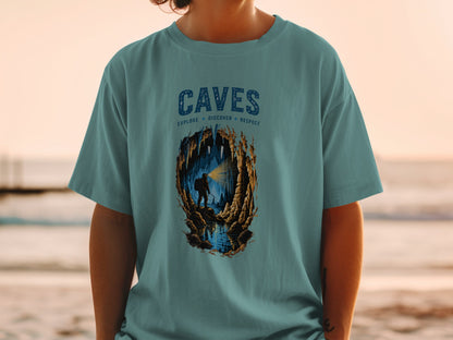 Teal t-shirt with "CAVES EXPLORE DISCOVER RESPECT" and cave explorer graphic.