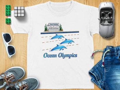 White t-shirt with cartoon dolphins swimming and text "Ocean Olympics".