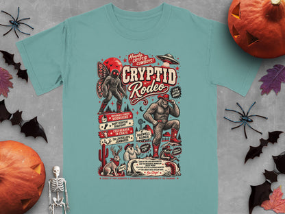 "Cryptid Rodeo" graphic tee with Bigfoot, mothman, jackalope, UFO, and other cryptids.