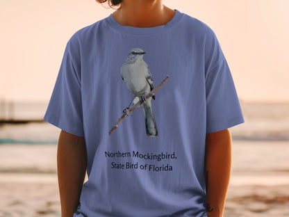 Northern Mockingbird, State Bird of Florida printed on a blue t-shirt.