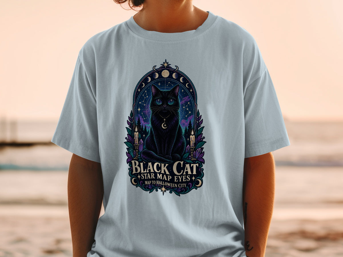 Black cat with star map eyes on a t-shirt with text "Black Cat Star Map Eyes Map to Halloween City".