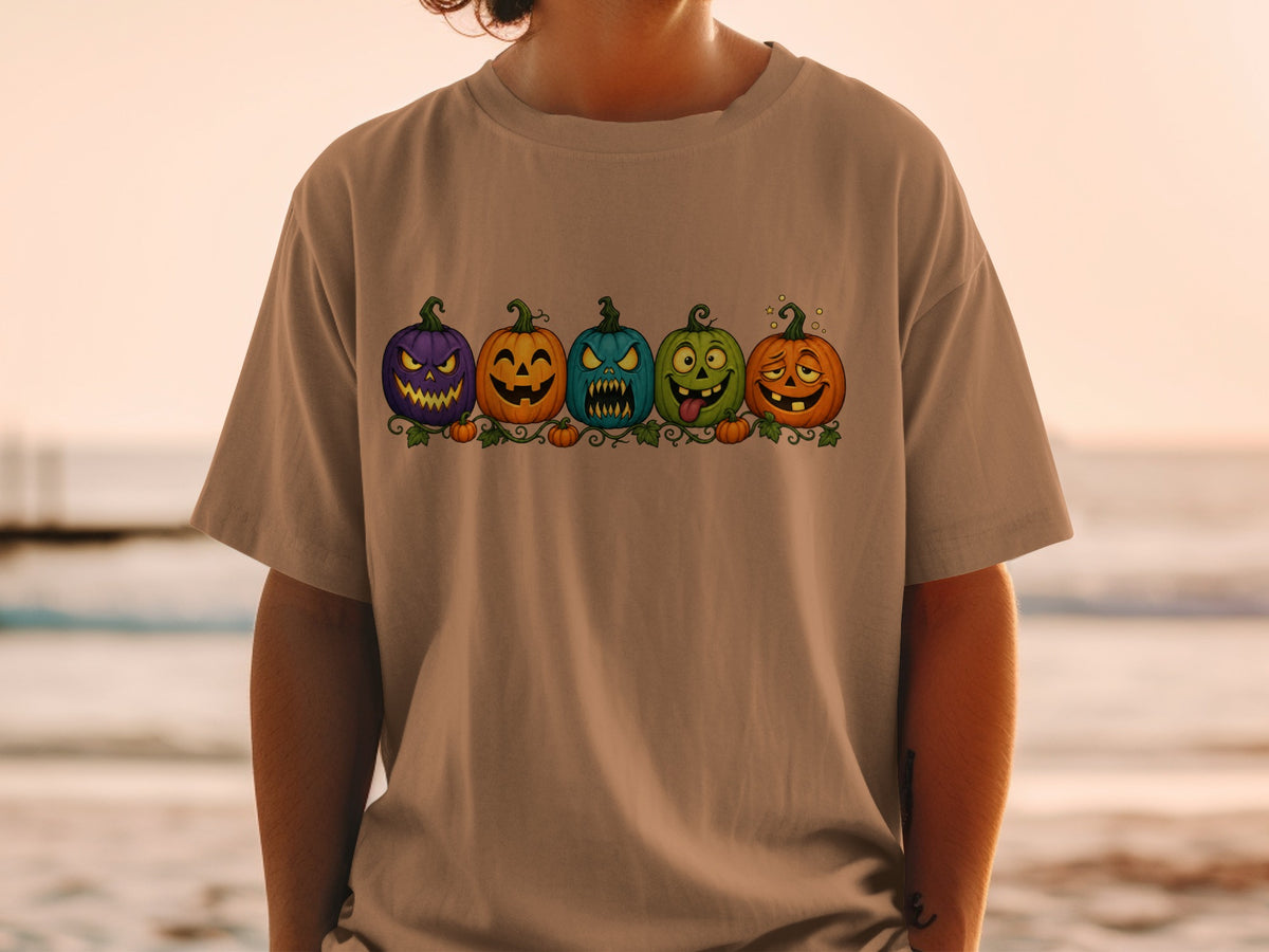 T-shirt with a row of five cartoon Halloween pumpkins with different spooky expressions.