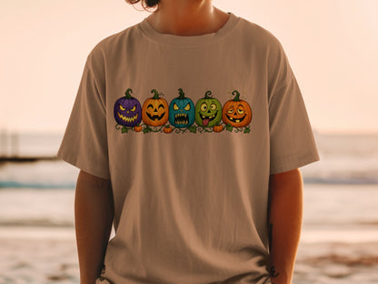 T-shirt with a row of five cartoon Halloween pumpkins with different spooky expressions.