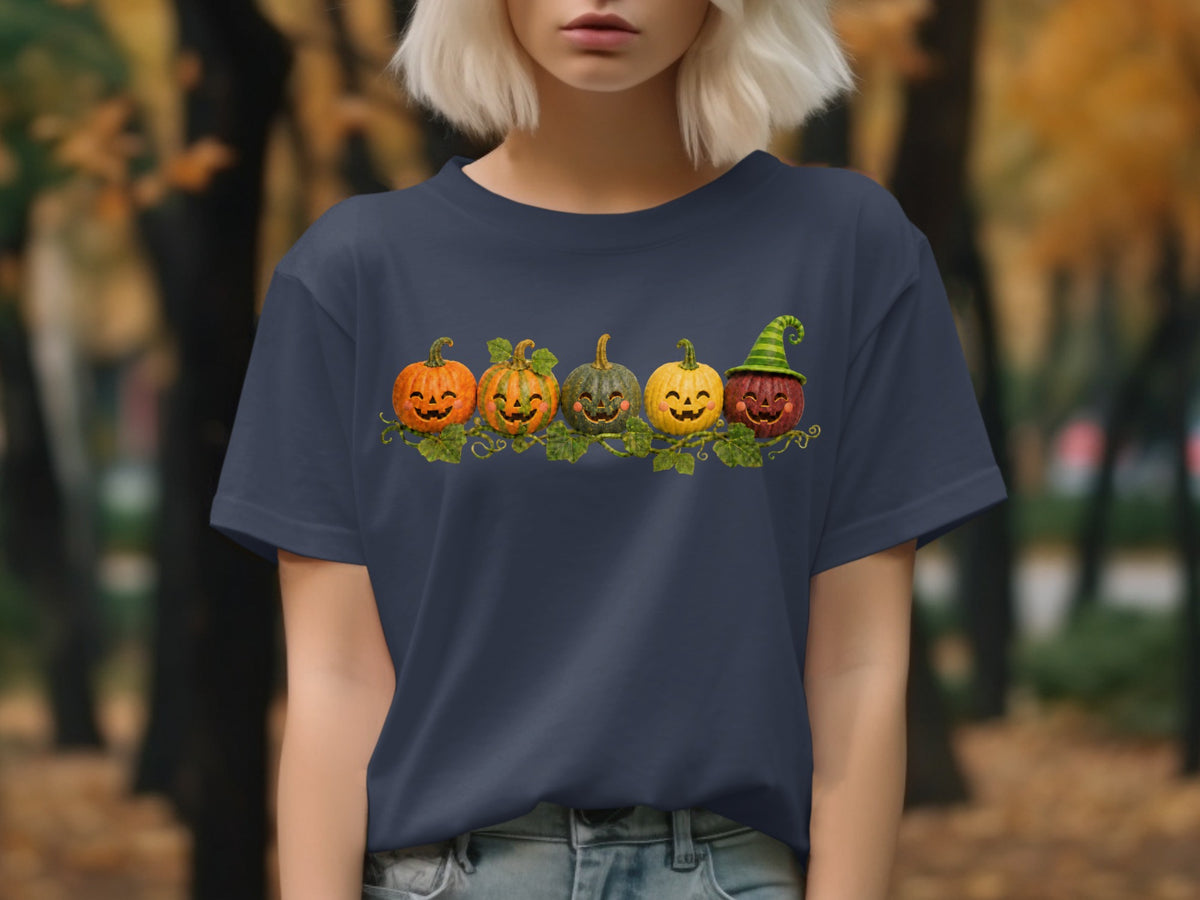 Dark blue t-shirt featuring a row of five smiling, carved pumpkins with vines.