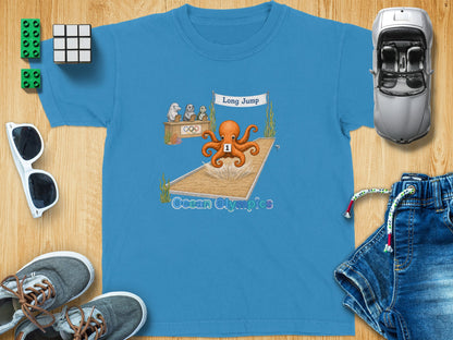 Ocean Olympics long jump graphic with octopus athlete on a blue t-shirt.