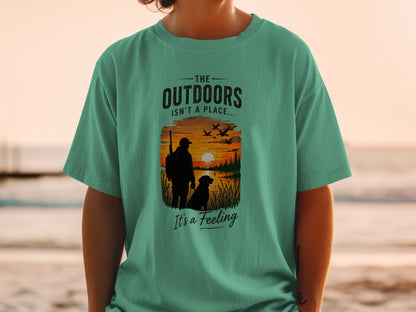 T-shirt graphic with text "The Outdoors Isn't a Place... It's a Feeling."