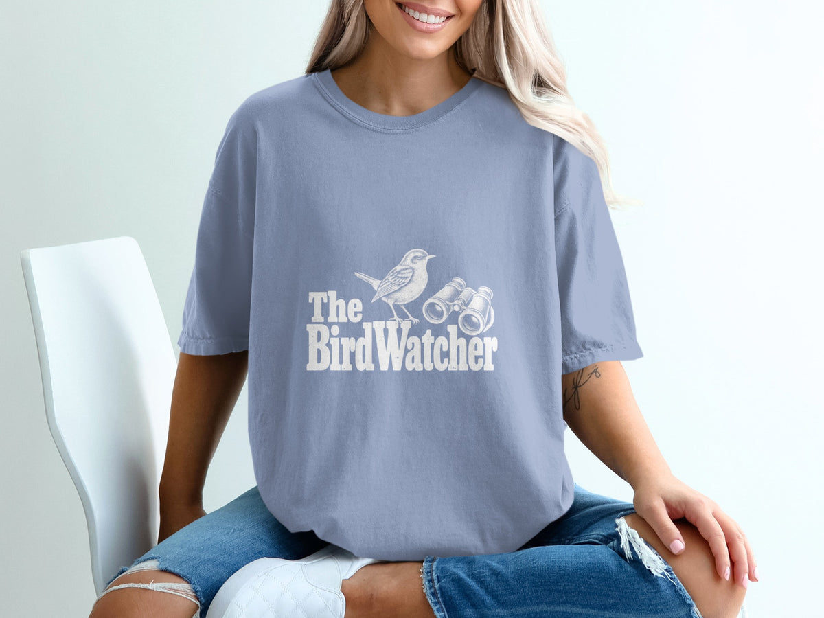 Blue t-shirt with white text and graphic of a bird and binoculars reading "The BirdWatcher".