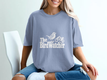 Blue t-shirt with white text and graphic of a bird and binoculars reading "The BirdWatcher".