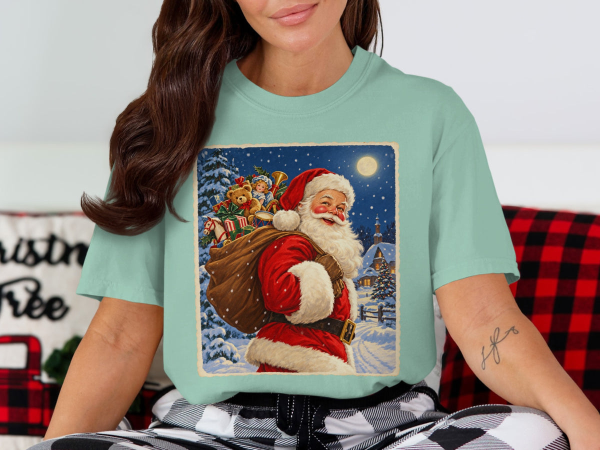 Santa carrying a sack of toys through a snowy village at night.