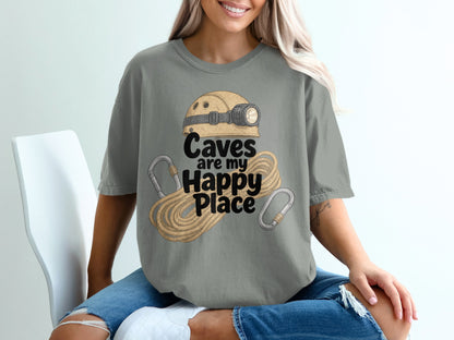 T-shirt graphic with caving helmet, rope, carabiners, and "Caves are my Happy Place" text.