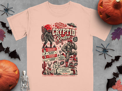 T-shirt featuring a "Cryptid Rodeo" design with Bigfoot, Mothman, Chupacabra, and UFO.