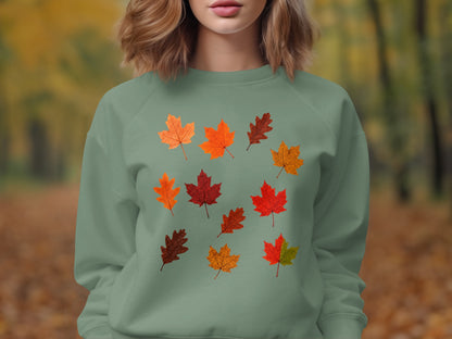 Light green sweatshirt with a scattered pattern of various autumn leaves.