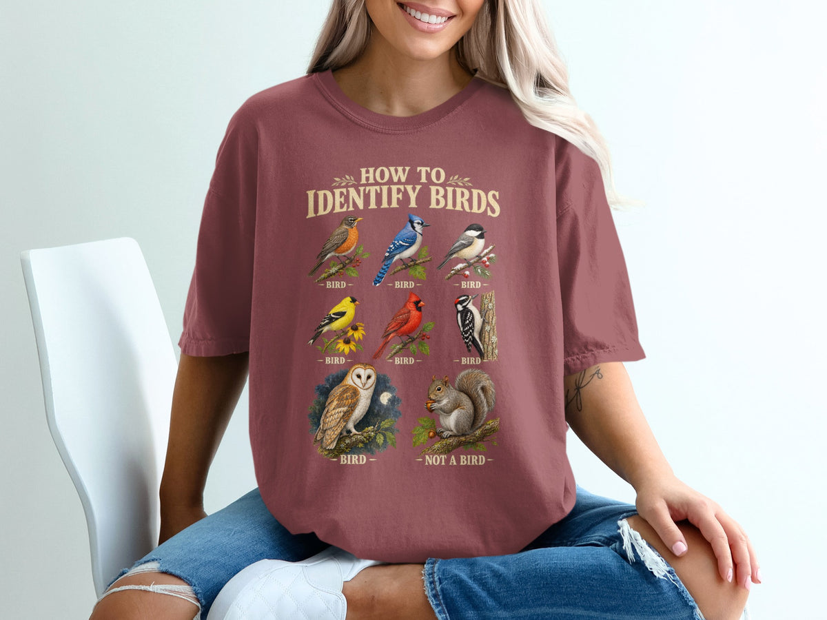 T-shirt with "How to Identify Birds" text and illustrations of various birds and a squirrel.