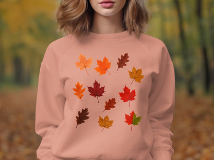Peach crewneck sweatshirt with an all-over pattern of colorful autumn leaves.